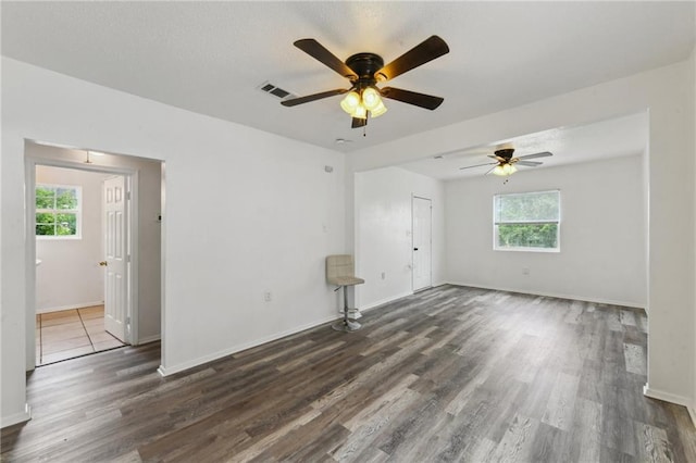 4601 Reynes St, New Orleans, LA 70126 - empty room with healthy amount of natural light, ceiling fan, and dark wood finished floors