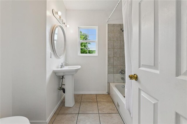 4601 Reynes St, New Orleans, LA 70126 - full bath featuring tile patterned floors and shower / tub combo with curtain