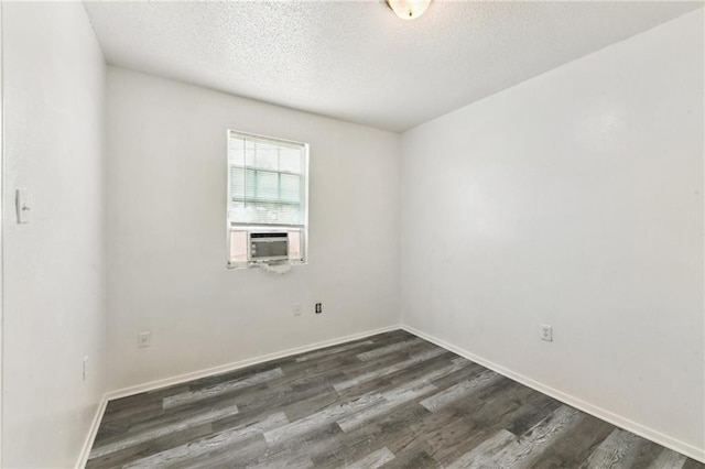 4601 Reynes St, New Orleans, LA 70126 - unfurnished room featuring dark wood-type flooring, a textured ceiling, and cooling unit