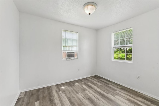 4601 Reynes St, New Orleans, LA 70126 - spare room featuring cooling unit, wood finished floors, and a textured ceiling