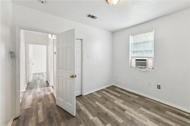 4601 Reynes St, New Orleans, LA 70126 - empty room with attic access, wood finished floors, cooling unit, and a textured ceiling