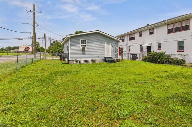 4601 Reynes St, New Orleans, LA 70126 - rear view of property with entry steps and a fenced backyard