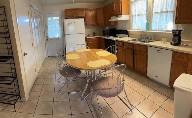 121 Sigma St, Belle Chasse, LA 70037 - kitchen with white appliances, under cabinet range hood, plenty of natural light, and light countertops