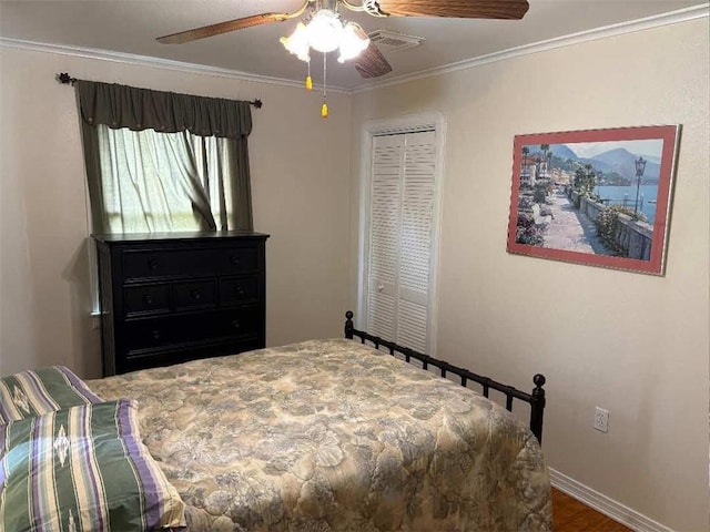 121 Sigma St, Belle Chasse, LA 70037 - bedroom featuring a closet, ornamental molding, a ceiling fan, and dark wood-style flooring