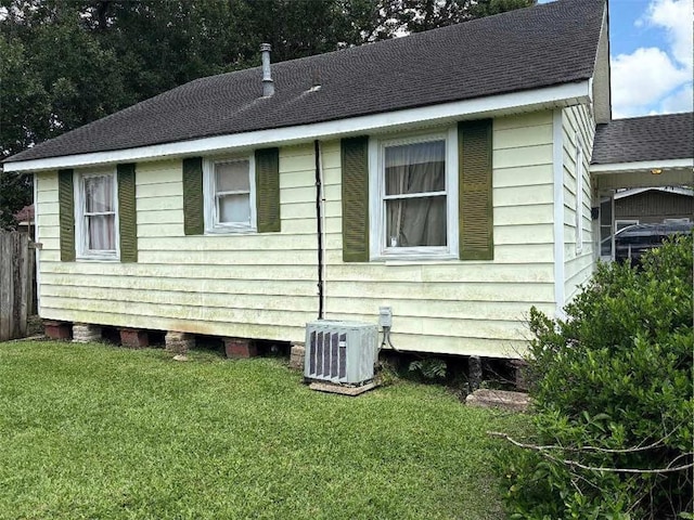 121 Sigma St, Belle Chasse, LA 70037 - view of side of property featuring a central AC unit and a shingled roof