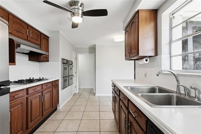 4517 Purdue Dr, Metairie, LA 70003 - kitchen with appliances with stainless steel finishes, ceiling fan, under cabinet range hood, light countertops, and crown molding