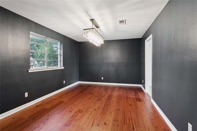 4517 Purdue Dr, Metairie, LA 70003 - unfurnished room featuring a chandelier and wood-type flooring