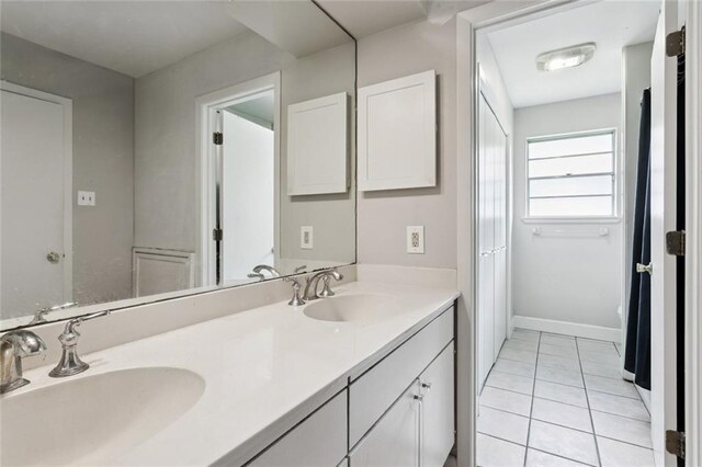 4517 Purdue Dr, Metairie, LA 70003 - bathroom with double vanity and tile patterned flooring