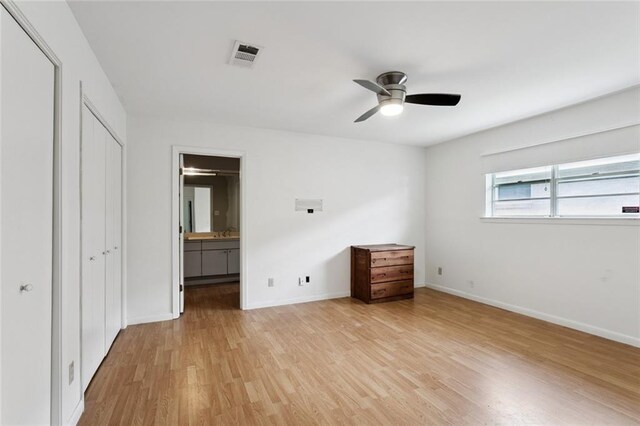 4517 Purdue Dr, Metairie, LA 70003 - unfurnished bedroom featuring light wood-style floors, ensuite bathroom, and a ceiling fan