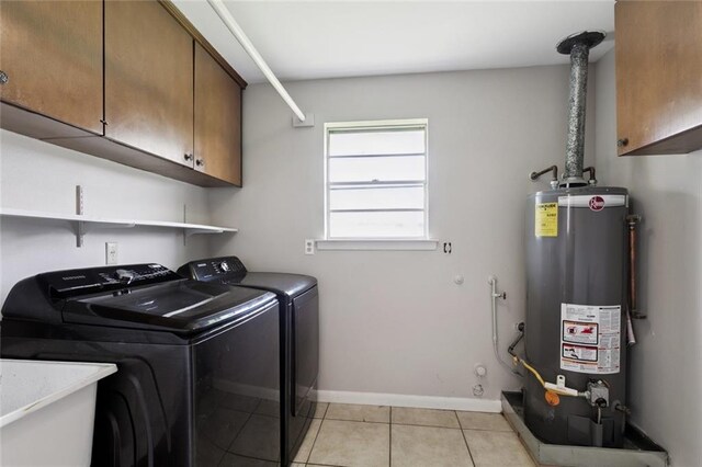 4517 Purdue Dr, Metairie, LA 70003 - laundry area with gas water heater, cabinet space, washing machine and clothes dryer, and light tile patterned floors