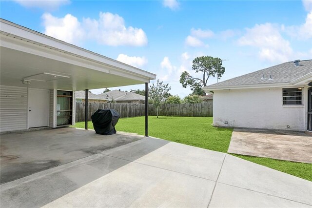 4517 Purdue Dr, Metairie, LA 70003 - fenced backyard with a patio area, concrete driveway, and a grill
