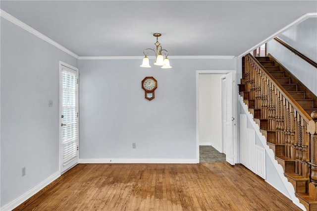 174 Celia Dr, Luling, LA 70070 - spare room with stairs, wood finished floors, a chandelier, and crown molding