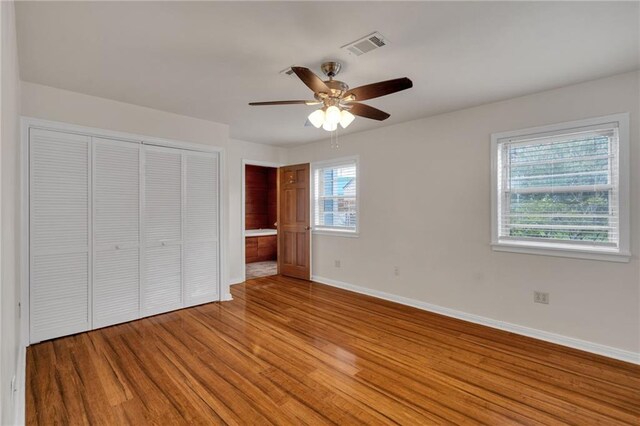 174 Celia Dr, Luling, LA 70070 - unfurnished bedroom featuring light wood-style floors, a closet, ceiling fan, and connected bathroom