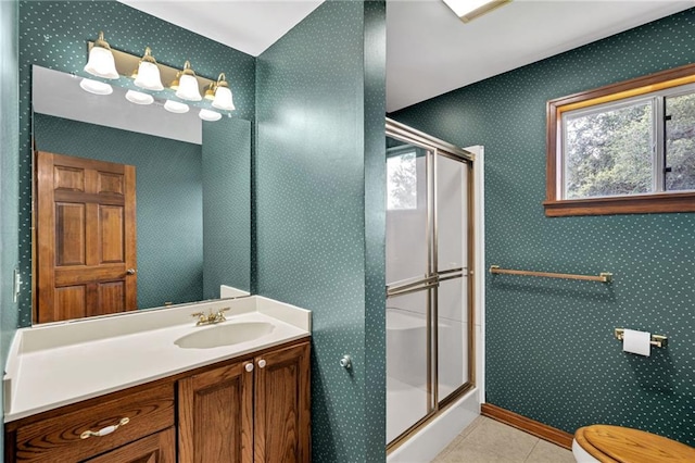 174 Celia Dr, Luling, LA 70070 - bathroom with a stall shower, vanity, tile patterned floors, and wallpapered walls
