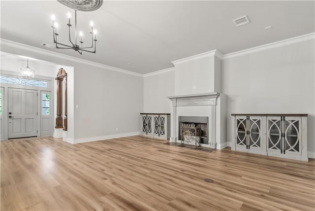 71434 Saint Joseph St, Abita Springs, LA 70420 - unfurnished living room featuring a chandelier, ornamental molding, wood finished floors, and a fireplace with flush hearth