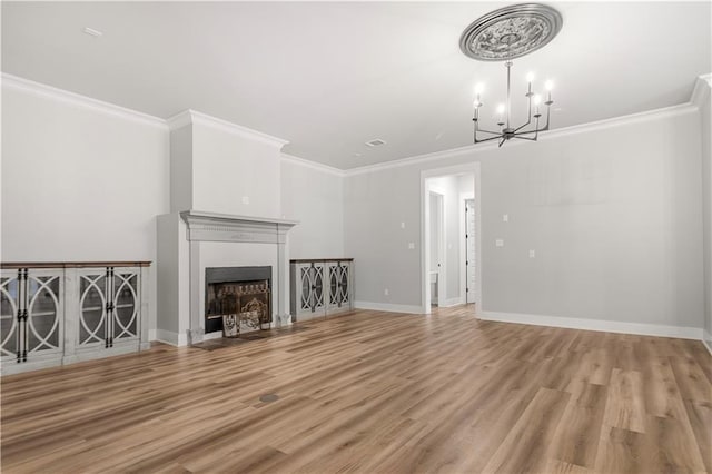 71434 Saint Joseph St, Abita Springs, LA 70420 - unfurnished living room featuring a chandelier, ornamental molding, light wood-style flooring, and a fireplace with flush hearth