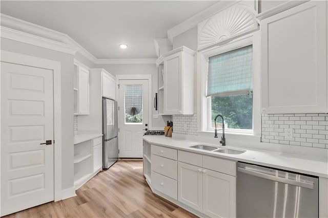 71434 Saint Joseph St, Abita Springs, LA 70420 - kitchen featuring appliances with stainless steel finishes, open shelves, white cabinets, light countertops, and crown molding