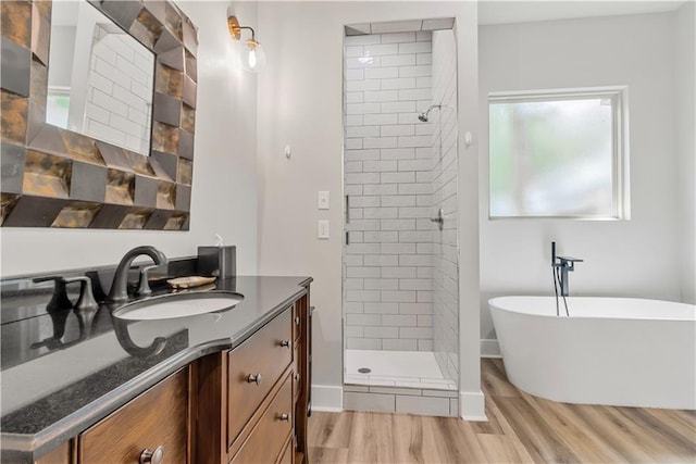 71434 Saint Joseph St, Abita Springs, LA 70420 - full bathroom featuring vanity, a freestanding tub, a shower stall, and wood finished floors