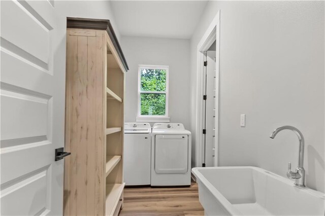 71434 Saint Joseph St, Abita Springs, LA 70420 - laundry area featuring washer and dryer and light wood-style floors