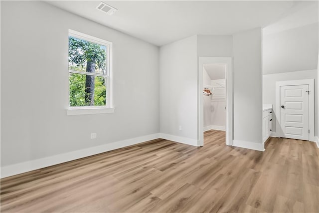 71434 Saint Joseph St, Abita Springs, LA 70420 - unfurnished bedroom with light wood-style floors, a spacious closet, and a closet