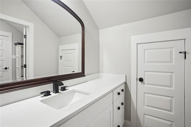 71434 Saint Joseph St, Abita Springs, LA 70420 - bathroom featuring vaulted ceiling and vanity