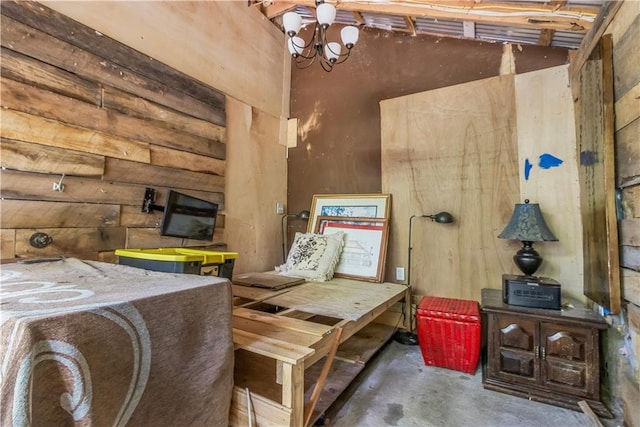 71434 Saint Joseph St, Abita Springs, LA 70420 - misc room with unfinished concrete flooring, wood walls, and a chandelier