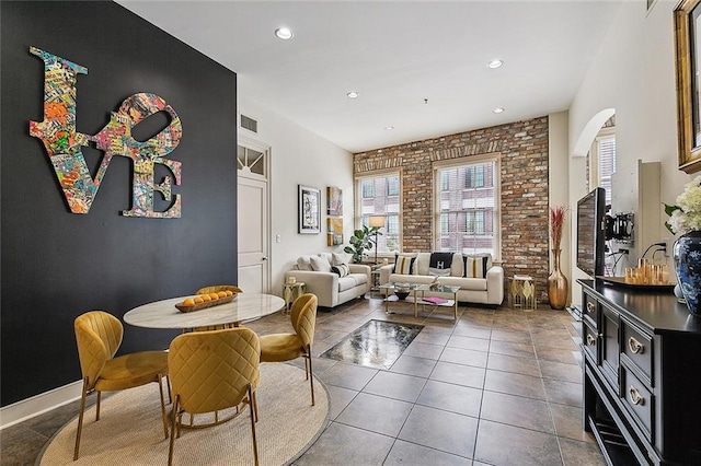 333 Girod St Unit 304, New Orleans, LA 70130 - dining space featuring brick wall, recessed lighting, and tile patterned flooring