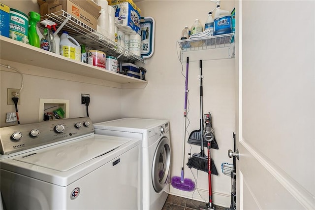 333 Girod St Unit 304, New Orleans, LA 70130 - washroom featuring washer and clothes dryer and dark tile patterned flooring