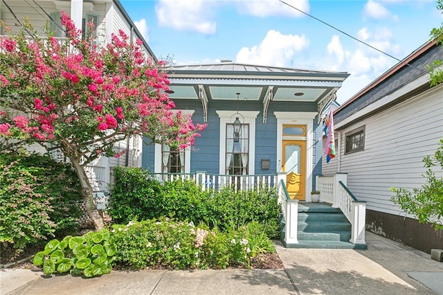 422 Alix St, New Orleans, LA 70114 - doorway to property featuring a porch, a standing seam roof, and a metal roof