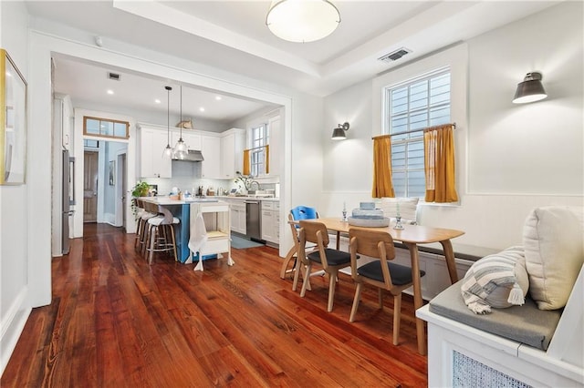 422 Alix St, New Orleans, LA 70114 - dining space featuring dark wood-style flooring, a tray ceiling, and recessed lighting