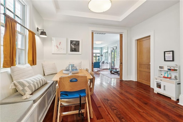 422 Alix St, New Orleans, LA 70114 - dining space with wood finished floors, a raised ceiling, and wainscoting