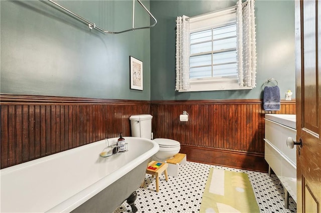 422 Alix St, New Orleans, LA 70114 - bathroom with a freestanding tub, a wainscoted wall, wood walls, vanity, and tile patterned floors
