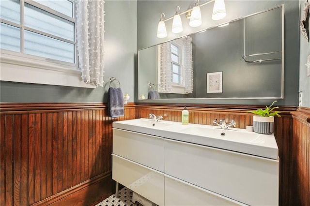 422 Alix St, New Orleans, LA 70114 - full bathroom featuring double vanity, a wainscoted wall, and wood walls