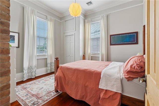 422 Alix St, New Orleans, LA 70114 - bedroom featuring dark wood-type flooring and crown molding