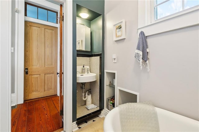 422 Alix St, New Orleans, LA 70114 - bathroom featuring wood finished floors and a tub