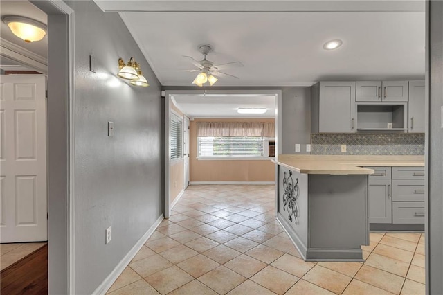 7 Albert Ct, Metairie, LA 70003 - kitchen featuring gray cabinetry, light tile patterned floors, tasteful backsplash, light countertops, and recessed lighting