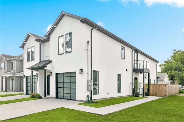 4544 Prairie St, Metairie, LA 70001 - view of front facade featuring a balcony, an attached garage, concrete driveway, and stucco siding
