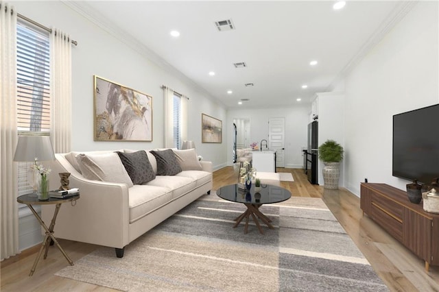 4544 Prairie St, Metairie, LA 70001 - living room featuring light wood-type flooring, plenty of natural light, recessed lighting, and ornamental molding