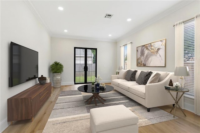 4544 Prairie St, Metairie, LA 70001 - living area featuring light wood finished floors, crown molding, recessed lighting, and french doors