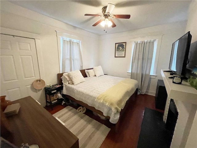7935 Fig St, New Orleans, LA 70125 - bedroom featuring wood finished floors, a ceiling fan, and a fireplace