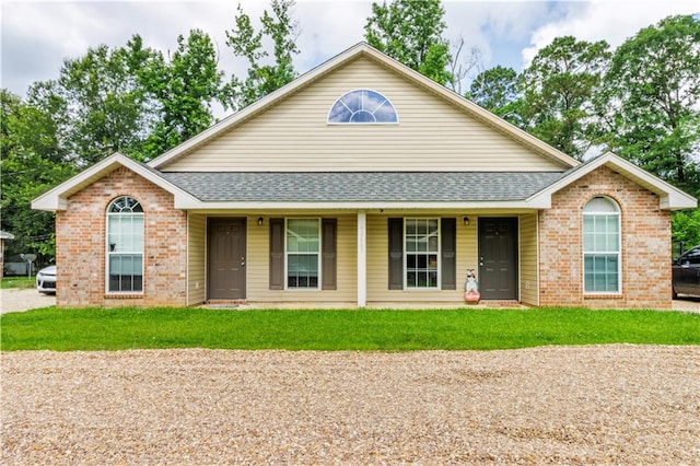 42653-42663 Edgewater Ln, Hammond, LA 70403 - ranch-style house with roof with shingles, brick siding, a porch, and a front lawn