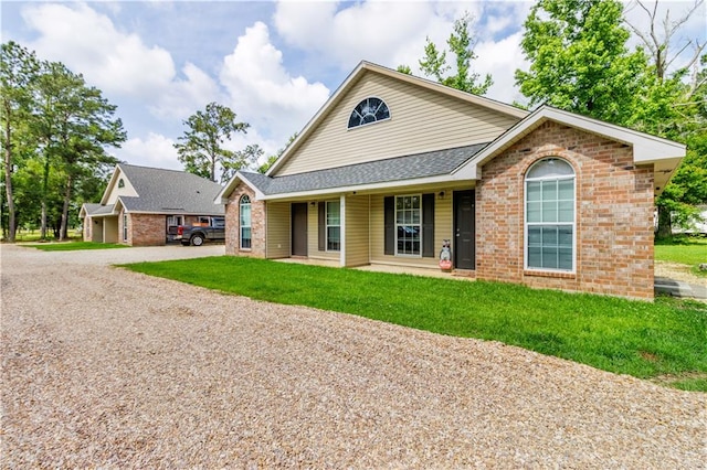 42653-42663 Edgewater Ln, Hammond, LA 70403 - view of front of property featuring brick siding, gravel driveway, a front yard, and roof with shingles