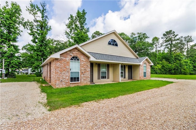 42653-42663 Edgewater Ln, Hammond, LA 70403 - ranch-style home featuring gravel driveway, brick siding, a front lawn, a shingled roof, and covered porch