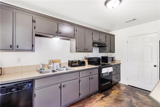 42653-42663 Edgewater Ln, Hammond, LA 70403 - kitchen featuring black appliances, under cabinet range hood, light countertops, and gray cabinets