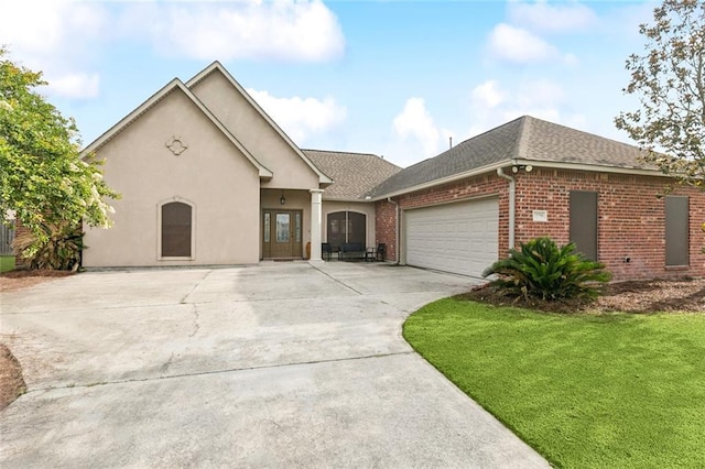 13795 Shady Hollow Dr, Denham Springs, LA 70726 - view of front of house featuring brick siding, a garage, concrete driveway, a shingled roof, and a front lawn
