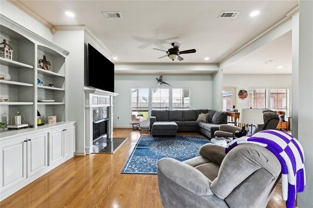 13795 Shady Hollow Dr, Denham Springs, LA 70726 - living area with light wood-style flooring, ceiling fan, a fireplace, plenty of natural light, and recessed lighting