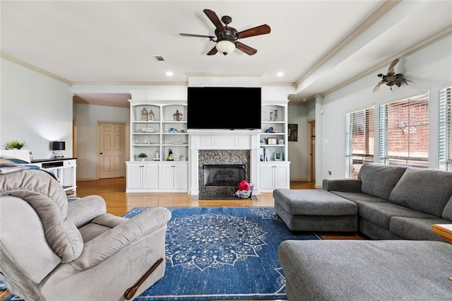 13795 Shady Hollow Dr, Denham Springs, LA 70726 - living room with ornamental molding, a ceiling fan, a high end fireplace, light wood finished floors, and recessed lighting