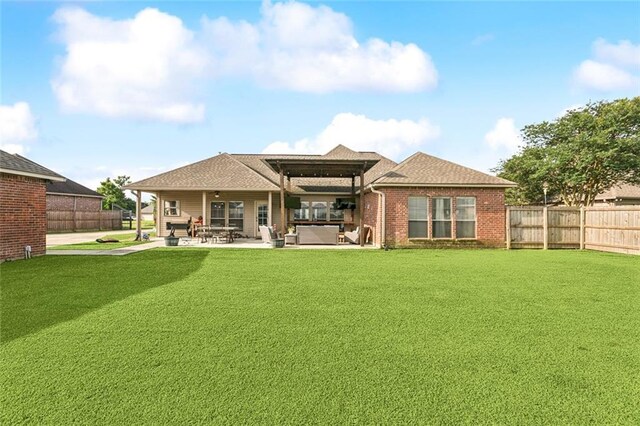 13795 Shady Hollow Dr, Denham Springs, LA 70726 - rear view of house featuring a fenced backyard, a patio, roof with shingles, brick siding, and an outdoor hangout area