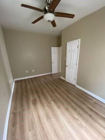 1317-1919 S Genois St, New Orleans, LA 70125 - unfurnished bedroom with wood finished floors, ceiling fan, and a closet