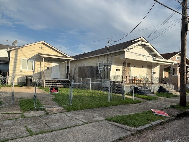 1317-1919 S Genois St, New Orleans, LA 70125 - shotgun-style home featuring a gate, a fenced front yard, and stucco siding